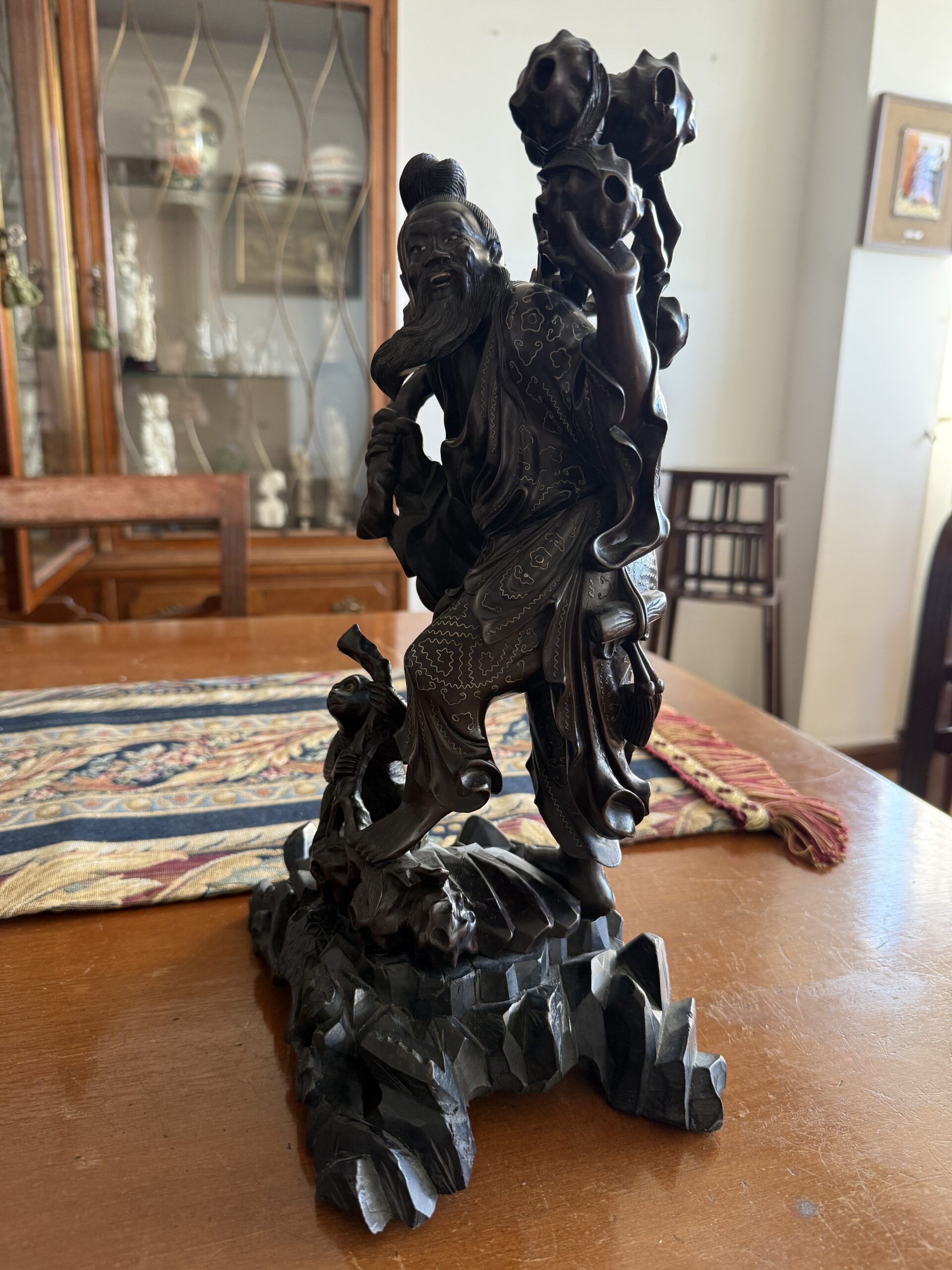 Figura oriental tallada en madera con personaje tradicional